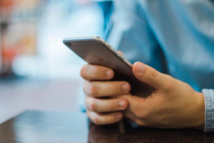Hands holding a smartphone mid-message